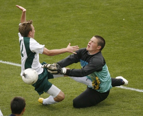 Trent Nelson  |  The Salt Lake Tribune
Waterford goalkeeper makes the save as St. Joseph's Zee Kim charges in. Waterford defeats St. Joseph 2-1 in the 2A State Championship high school soccer game at Rio Tinto Stadium, in Sandy, Utah, Saturday, May 14, 2011.