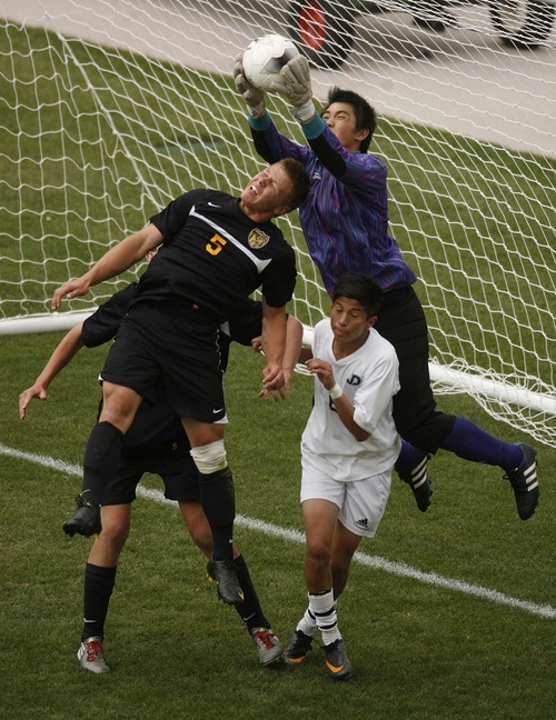 Trent Nelson  |  The Salt Lake Tribune
Juan Diego goalkeeper Du Nguyen makes the save over Wasatch's KB Bonner. Juan Diego vs. Wasatch in the 3A State Championship high school soccer game at Rio Tinto Stadium, in Sandy, Utah, Saturday, May 14, 2011. Juan Diego's Isaiah Garcia at bottom right.