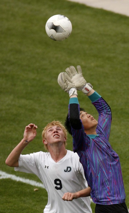 Trent Nelson  |  The Salt Lake Tribune
Juan Diego goalkeeper reaches up for the save, with teammate Bobby Sullivan at left. Juan Diego vs. Wasatch in the 3A State Championship high school soccer game at Rio Tinto Stadium, in Sandy, Utah, Saturday, May 14, 2011.