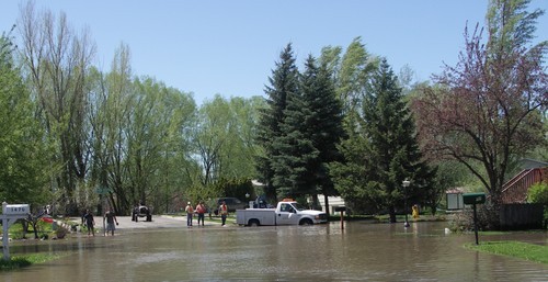 Arrin Newton Brunson  |  The Salt Lake Tribune
Floodwater from the Blacksmith Fork River breached a sandbag levee at approximately 9:50 a.m. Sunday, filling the streets, including Country Manor Drive, shown here, and several homes in Country Manor Subdivision in south Logan. The levee was repaired by noon; the water receded and the evacuation was lifted at 2 p.m.