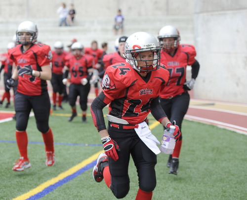 Sarah A. Miller  |  The Salt Lake Tribune

Utah Blitz player Chrystle runs back with her teammates for the start of the second half of their game at the Judge Memorial High School football field Saturday afternoon May 14, 2011. The all-female team played the Las Vegas Show Girlz.