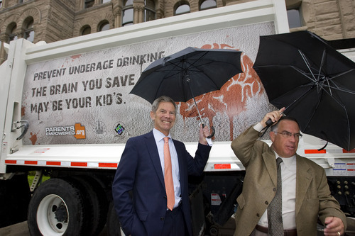 Al Hartmann  |  The Salt Lake Tribune
Salt Lake City Mayor Ralph Becker, left,  and Sam Granato, chairman of the Utah Department of Alcoholic Beverage Control Commission,  show  the new underage drinking message that will appear on the sides of  Salt Lake City sanitation trucks. The announcement was made at the Salt Lake City County Building on Wednesday, May 18.