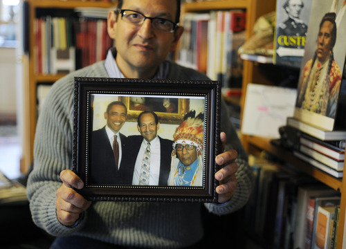 Sarah A. Miller  |  The Salt Lake Tribune

Artifact collector Christopher Kortlander holds a photo of himself with President Barack Obama, left, and Dr. Joe Medicine Crow, right, after Crow received the Presidential Medal of Freedom. Kortlander is suing the federal government, saying it violated his rights during a raid of artifacts that occurred on his property in 2005.