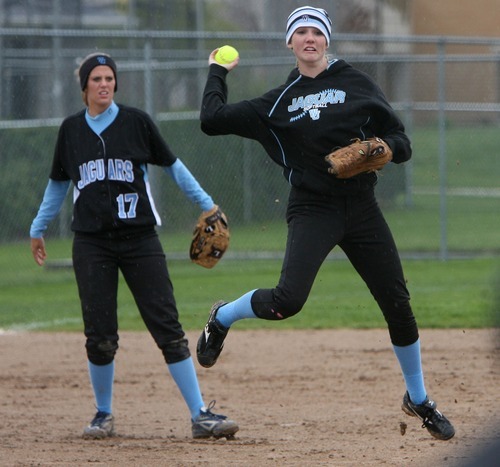 Steve Griffin  |  The Salt Lake Tribune

 West Jordan shortstop Lindsey Drake leaps into the air as she fires to first for an out during game against Murray at the Salt Community College in Taylorsville, Utah Wednesday, May 18, 2011. West Jordan third baseman Breea Buckley looks on.