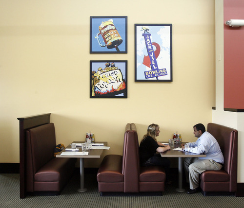 Francisco Kjolseth  |  The Salt Lake Tribune
The dining room of Fin & Norah's in South Jordan is lined with images of classic buildings from around the valley, such as the iconic Rio Grande, Bongo Lounge and Crane Building.