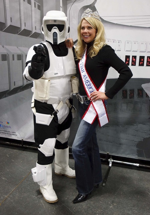 Trent Nelson  |  The Salt Lake Tribune
Dressed as an Imperial scout trooper, Ryan Simmons poses with Mrs. Utah America Carol Guest at the Utah Baby and Kidz Expo. Simmons and other members of the Alpine Garrison volunteer their time dressing up in Star Wars costumes to entertain children and raise money for charities.