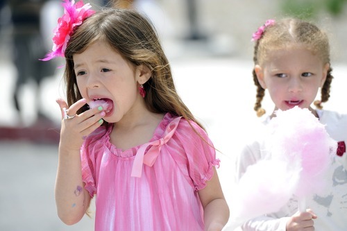 Sarah A. Miller  |  The Salt Lake Tribune

Madeleine Gonzales, 6, left, and Sari Goodspeed, 4, both of Salt Lake City, eat cotton candy at the third annual CommUNITY Fair held at the Sorenson Unity Center in Salt Lake City on Friday. he event celebrated the cultural diversity and unique community of the Glendale and Poplar Grove areas. The event also served as the kick-off for the newly created Unity Gardens, a 24-plot community garden located behind the center.