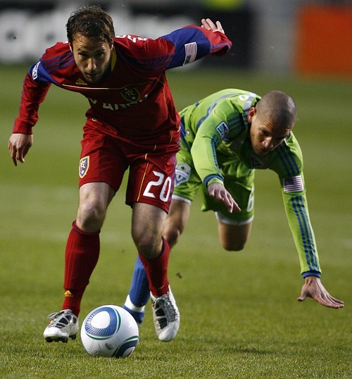 Djamila Grossman  |  The Salt Lake Tribune

Real Salt Lake plays the Seattle Sounders at Rio Tinto Stadium in Sandy, Utah, on Saturday, May 28, 2011. Real's Ned Grabavoy (20) keeps running with the ball as the Sounders' Osvaldo Alonso (6) falls trying to reach him.