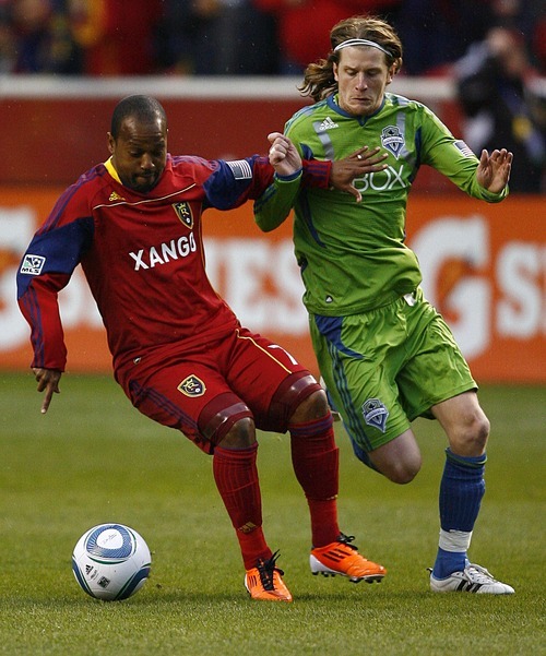 Djamila Grossman  |  The Salt Lake Tribune

Real Salt Lake plays the Seattle Sounders at Rio Tinto Stadium in Sandy, Utah, on Saturday, May 28, 2011.  Real's Andy Williams (77) defends the ball against the Sounders' Erik Friberg (8).