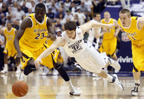Trent Nelson  |  The Salt Lake Tribune
Wyoming's Djibril Thiam knocks the ball loose from BYU's Jimmer Fredette as BYU hosts Wyoming, college basketball in Provo, Utah, Saturday, March 5, 2011. Wyoming's JayDee Luster at right.