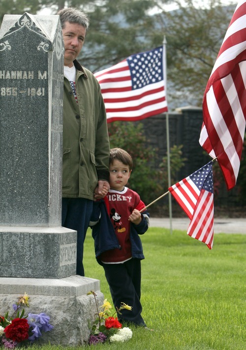 Rick Egan   |  The Salt Lake Tribune
Scott Gaffney and his son Lincoln, 4, listen to Jay W. Neilson as he reads the names of veterans buried at the Bluffdale Cemetery  during Memorial Day services Monday.