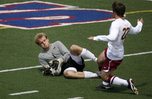 Trent Nelson  |  The Salt Lake Tribune
Highland goalkeeper Hayes Hicken makes a save on Mountain View's Dover Janis. Mountain View defeats Highland 3-0 in the 4A state high school soccer playoffs in Woods Cross.