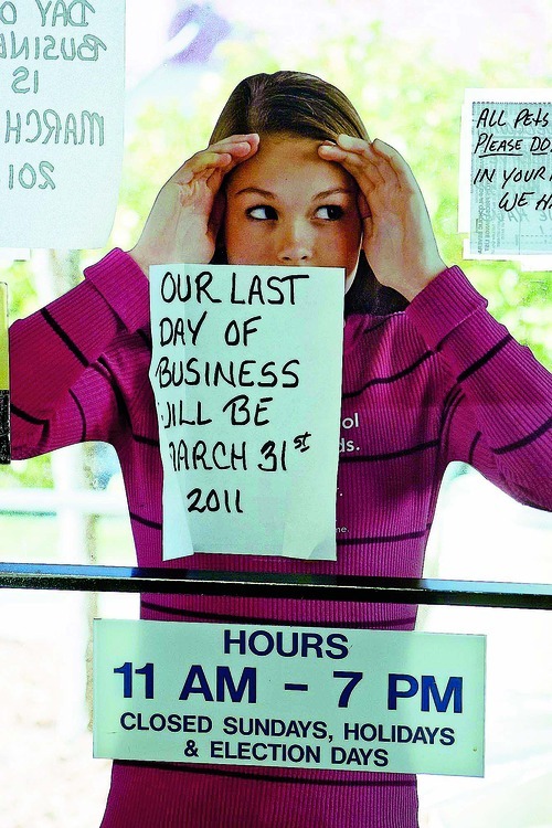 Trent Nelson  |  The Salt Lake Tribune
A cardboard image of a girl looks through a state liquor store's door. The signs posted on the glass door announced the last day of business of the store on 1457 S. Main St., Salt Lake City, in March.