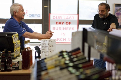 Trent Nelson  |  The Salt Lake Tribune

Tony Placencio, left, and Chuck Waagen, the manager of the state liquor store on Main Street in Salt Lake City, share memories as the store closed for business in March.