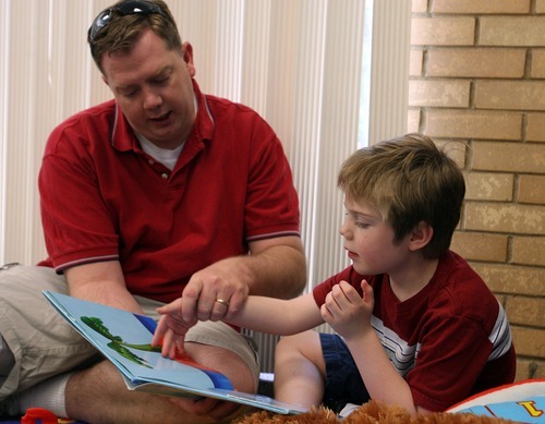 Leah Hogsten  |  The Salt Lake Tribune
Stephen Gale reads to his son Parker, 6, who has autism, during craft time at the Kearns Library on Saturday.