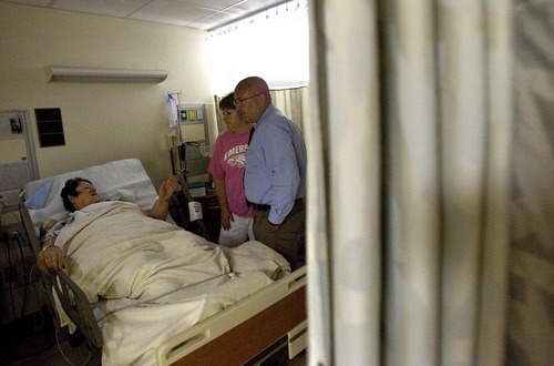 Djamila Grossman  |  The Salt Lake Tribune

Susan Hughlett of Joplin, Missouri, rests in a hospital bed in Springfield, Missouri, after being injured in the recent tornado that tore down parts of the city, on Wednesday, June 1, 2011. Hughlett, a member of The Church of Jesus Christ of Latter-Day Saints, receives a visit by Dave Richins and his wife Carolyn. Richins is the bishop of her Second Ward in Joplin.
