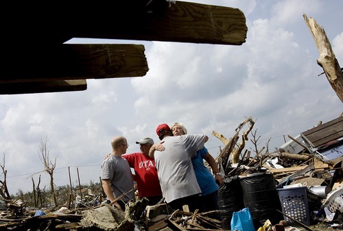 Djamila Grossman  |  The Salt Lake Tribune

Marsha Crowder hugs Joplin, Missouri, resident Tim Bartow, as her husband, The Rev. Myke Crowder talks to Adam Wright after the family's home was destroyed in the recent tornado on Wednesday, June 1, 2011. The Crowders came from Utah to help with donations. Both grew up in Joplin.