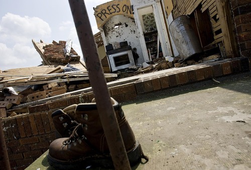 Djamila Grossman  |  The Salt Lake Tribune

Shoes stand on the front porch, with an exposed kitchen in the back on the property of Tim Bartow that was destroyed in the recent tornado in Joplin, Missouri, on Wednesday, June 1, 2011.