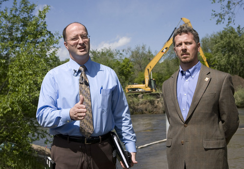 Al Hartmann  |  The Salt Lake Tribune
Scott Baird, Salt Lake County's director of flood control, left, and Patrick Leary, director of Salt Lake Public Works, hold a press conference on the shore of the Jordan RIver near 1300 South and 900 West on Thursday to explain the county's preparations for the late spring runoff.