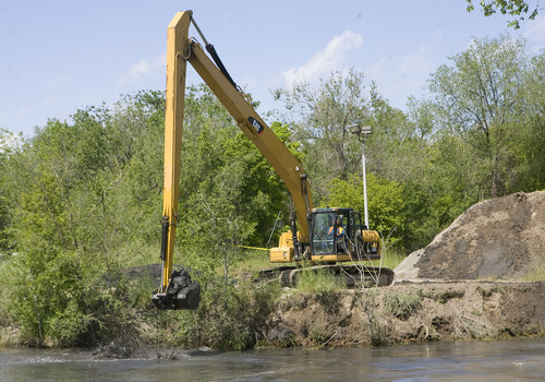 Al Hartmann  |  The Salt Lake Tribune
A backhoe near 1300 South and 900 West in Salt Lake City dredges the Jordan River to keep the channel open for spring runoff.