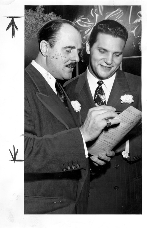 Tribune file photo

Arnold Hauslander poses for a photo with the head of catering at Hotel Utah, Henry Aloia, in December 1948.