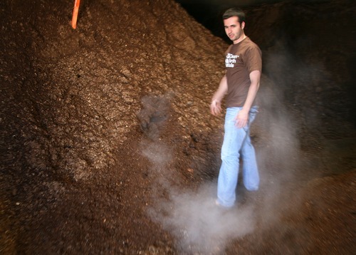 Steve Griffin  |  The Salt Lake Tribune

Steam from the composting process rises around Dan Blake, of EcoScraps, at the company's Salt Lake City plant. The company makes 100 percent organic soil with vegetables and fruit scraps through a special process similar to composting.