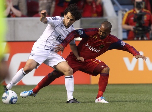 Rick Egan   |  The Salt Lake Tribune

Vancouver's Davide Chiumiento (20) collides with Andy Williams, in MLS action Real Salt Lake, vs Vancouver, at Rio TInto Stadium, Saturday, June 4, 2011