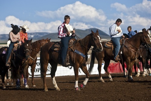 Chris Detrick  |  The Salt Lake Tribune 
Saxon Day, of Delta, center, joins other competitors in prayer before the Utah High School Finals Rodeo at the Wasatch County Special Event Center on Friday.