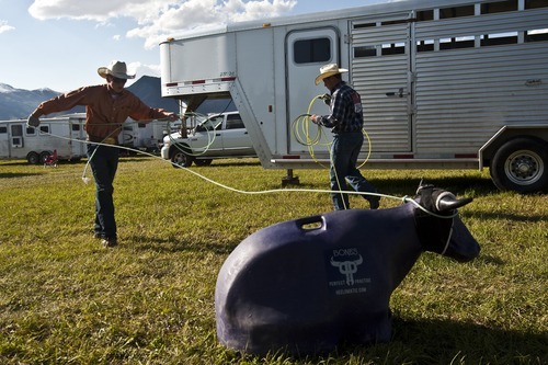 Chris Detrick  |  The Salt Lake Tribune 
Dylan Maughan, of Ogden, left, and Payden Stokes, of Ogden, practice their roping skills before the Utah High School Finals Rodeo at the Wasatch County Special Event Center on Friday.
