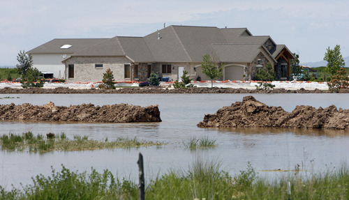 Francisco Kjolseth  |  The Salt Lake Tribune
One of the most threatened homes in West Warren on Friday, June 10, due to a breach in the Weber River.