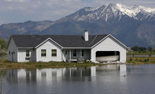 Francisco Kjolseth  |  The Salt Lake Tribune
Many Homes in West Warren have been threatened by rising waters as a significant snow pack continues to melt. Weber County's Incident command manages repairs to a broken levee along the Weber River in West Warren on Friday, June 10, 2011, with help from the Utah National Guard and contractor Randy Marriott Construction. Two black hawk helicopters were brought in to move large sand bags into the area while ground crews try to shore up the area that breached to hold the bags in place.