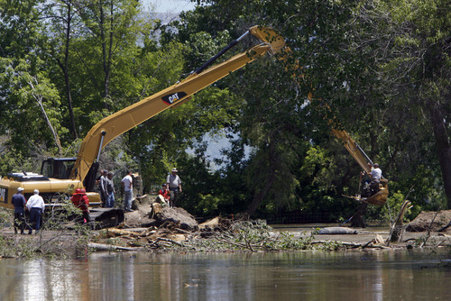 Francisco Kjolseth  |  The Salt Lake Tribune
Weber County's Incident command manages repairs to a broken levee along the Weber River in West Warren on Friday with help from the Utah National Guard and contractor Randy Marriott Construction. Two black hawk helicopters were brought in to move large sand bags into the area while ground crews try to shore up the area that breached to hold the bags in place.