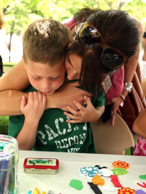 Leah Hogsten  |  The Salt Lake Tribune
Jackson Toliver, 6, of Ogden gets a hug from his mother Sara Toliver while making a treasure box at the eighth annual Ogden Arts Festival  at Ogden's Historic Union Station on Saturday in Ogden. The free event featured works of more than 60 local and regional artists, live music, exhibits and art activities for kids.