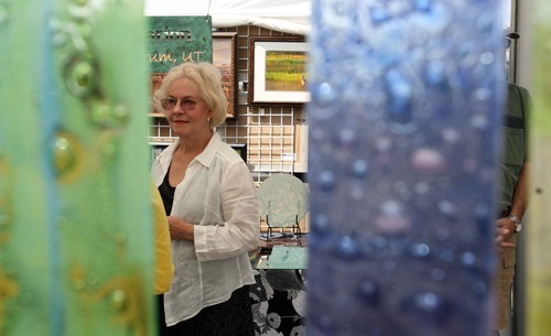 Leah Hogsten  |  The Salt Lake Tribune
Fused Glass artist Leona K. Hawks talks with visitors to her booth at the 8th annual Ogden Arts Festival  at Ogden's Historic Union Station,  Saturday, June 11 2011 in Ogden . The free event featured works of more than 60 local and regional artists, live music, exhibits and art activities for kids.