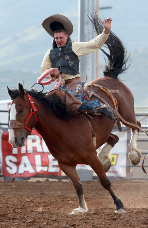 Rick Egan l The Salt Lake Tribune

McKay Magoon, Dixie, competes in the saddle bronc competition at the Utah High School Rodeo Championship round in Heber City, Saturday, June 10, 2011.