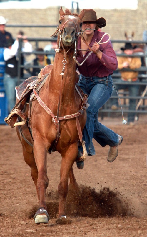 Rick Egan l The Salt Lake Tribune

Dally Bundy, Dixie, competes in the goat tying competition at the Utah High School Rodeo Championship round in Heber City, Saturday, June 10, 2011.