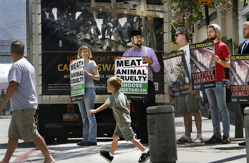 Scott Sommerdorf  |  The Salt Lake Tribune
Shoppers at The Gateway pass the animal rights group Mercy for Animals, which brought a specially modified truck with 80-inch movie screens to Rio Grande Street Saturday. The group showed the video 