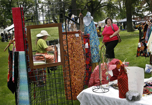 Scott Sommerdorf  |  The Salt Lake Tribune
Kay Robison sits reflected in a mirror at her booth 