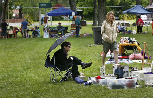 Scott Sommerdorf  |  The Salt Lake Tribune
Heidi Evans sits under an umbrella at her yard sale at the first day of the sixth annual Salt Lake People's Market held at Jordan Park, 1060 S. 900 West, Salt Lake City, Sunday, June 12, 2011.