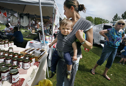 Scott Sommerdorf  |  The Salt Lake Tribune
Sue Diamond shops for jam with her one year old son, Milo in a sling at the first Wasatch Front Farmers Market at Wheeler Farm, 6351 S. 900 East, in Salt Lake City, Sunday, June 12, 2011.