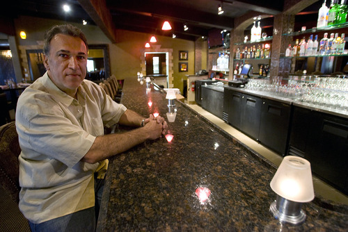 Al Hartmann  |  The Salt Lake Tribune
Dimitri Golesis sits at his empty bar at Golesis restaurant in Holladay. Although it's a fully functioning bar, it can't be used to make drinks and is seldom used by restaurant patrons. Club licenses are in such short supply that Dimitri Golesis has been waiting since November of last year to get one. He had to make do with a restaurant license, which required him to build a back room to hide bartenders from diners. Golesis says he has been losing business because customers want to watch their drinks being mixed, which under Utah is illegal with a restaurant license.