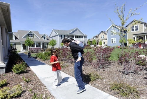 Sarah A. Miller  |  The Salt Lake Tribune

Adam Schafer plays with his daughters Eva, 8, left, and Keona, 5, right,  outside his Daybreak neighborhood home in South Jordan Tuesday May 31, 2011. Schafer lost his job last year, and now the family is facing foreclosure.
