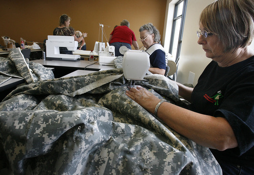 Scott Sommerdorf  |  The Salt Lake Tribune
Roma Knight, along with other volunteers, works at sewing quilts to be sent to soldiers in the Utah National Guard's 222nd Field Artillery Unit. Jackie Bulloch has organized a project to make quilts from special Army-issued camo fabric. She and other sewing volunteers worked at the 222nd Armory in Richfield on Monday.