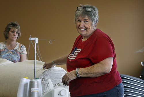 Scott Sommerdorf  |  The Salt Lake Tribune
Jackie Bulloch of Cedar City laughs with one of the volunteers who are making quilts to be sent to soldiers in the Utah National Guard's 222nd Field Artillery Unit. She has organized a project to make quilts from special Army-issued camo fabric. She and other sewing volunteers work at the 222nd Armory in Richfield on Monday.