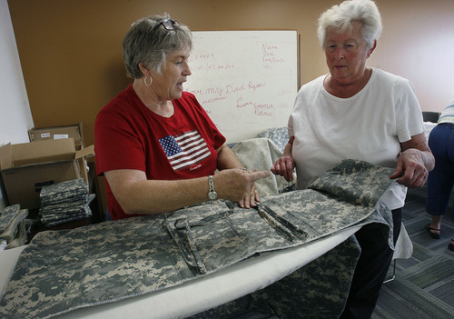 Scott Sommerdorf  |  The Salt Lake Tribune
Jackie Bulloch, left, speaks with Margaret Baker of Monroe about the construction of quilts for the Utah National Guard's 222nd Field Artillery Unit. Bulloch, a Cedar City woman who has three grandsons and a nephew in the unit, has organized a project to make quilts from special Army-issued camo fabric. She and other sewing volunteers work at the 222nd Armory in Richfield on Monday.