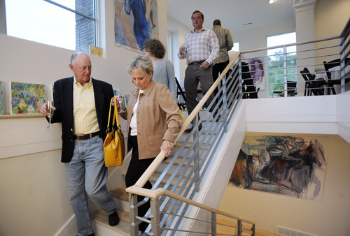 Sarah A. Miller  |  The Salt Lake Tribune
Tim and Mary Miller of Sandy walk downstairs to look at the artwork by Park City artist Josee Nadeau during the By Invitation Only dinner held at the Maple Heights Condominium complex in Salt Lake City on May 28, 2011. By Invitation Only is an underground restaurant that takes place once a month in Salt Lake City and Park City. Kinnaird sets up a dinner at a different 