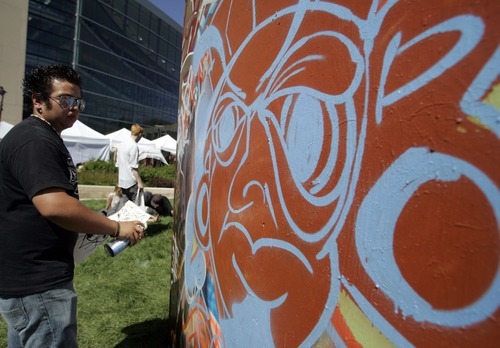 Jim Urquhart  |  The Salt Lake Tribune
Nicolas Solis, 17, of Santaquin, works on a piece at the graffiti cube at 2010's Utah Arts Festival.