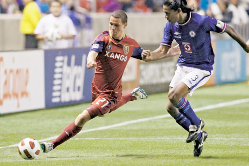 Chris Detrick  |  The Salt Lake Tribune 
Real Salt Lake midfielder Luis Gil #21 runs around Cruz Azul's Joel Huiqui Andrade during the first half of the game at Rio Tinto Stadium Tuesday October 19, 2010.  Real Salt Lake is winning the game 1-0.