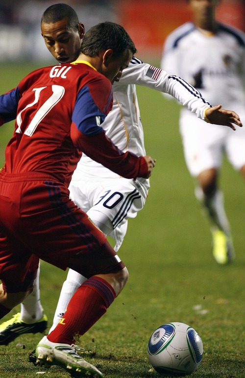 Djamila Grossman  |  The Salt Lake Tribune

Real Salt Lake's Luis Gil (21) defends the ball against Los Angeles Galaxy's Paolo Cardozo (30) during the second half of a game at Rio Tinto Stadium in Sandy, Utah, on Saturday,  March 26, 2011. RSL won the game.