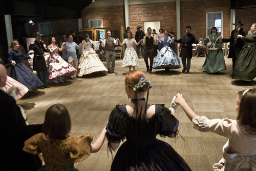 Chris Detrick  |  The Salt Lake Tribune 
Couples dance the Oslo waltz during a Civil War ball at the Fort Douglas Museum Friday. Several dozen re-enacters and historical dancers swept across the floor, dancing reels and quadrilles, contras and country dances in the new addition to the Fort Douglas Museum on the University of Utah campus.
